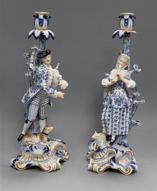 A pair of Meissen musical shepherd and shepherdess candlesticks, H 35cm
